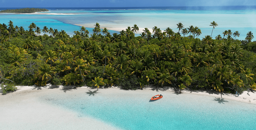 Lush island coastline with clear blue sea